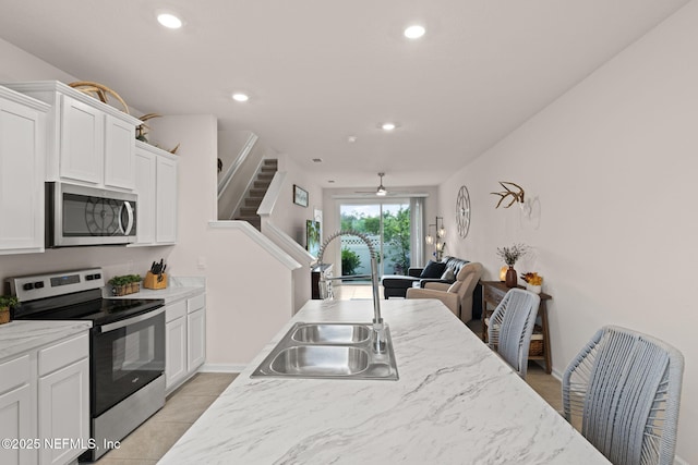 3937 Oak Mill Rd, Orange Park, FL 32065 - kitchen with a sink, recessed lighting, appliances with stainless steel finishes, and white cabinetry
