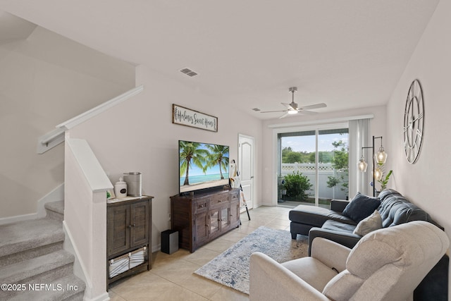 3937 Oak Mill Rd, Orange Park, FL 32065 - living area featuring visible vents, light tile patterned floors, baseboards, ceiling fan, and stairs
