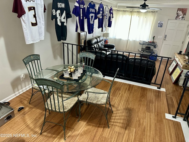 dining space featuring ornamental molding, baseboards, wood finished floors, and ceiling fan