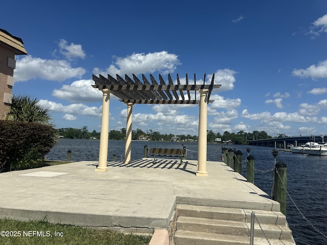 view of dock with a pergola, a water view, and a patio