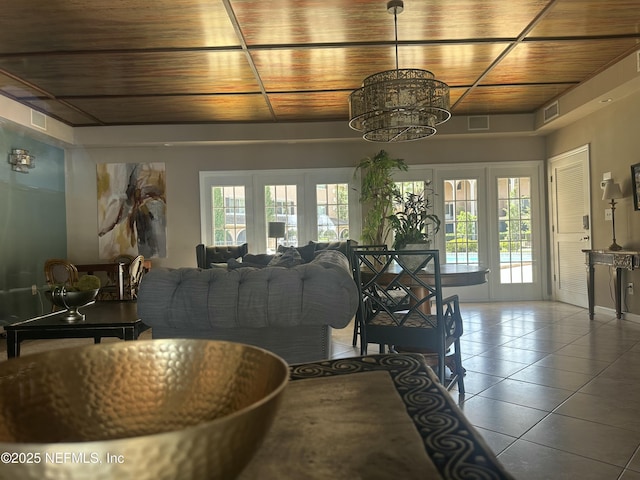 dining room with plenty of natural light, visible vents, tile patterned flooring, and a notable chandelier