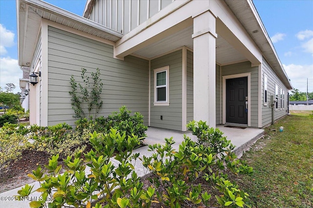 2176 Major Oak St, Jacksonville, FL 32218 - doorway to property with board and batten siding