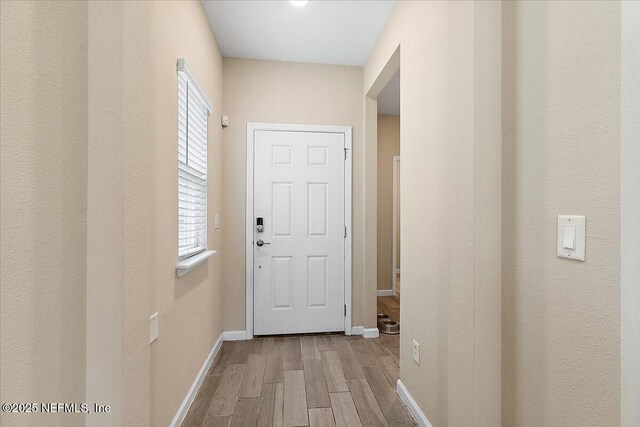 2176 Major Oak St, Jacksonville, FL 32218 - doorway to outside featuring baseboards, wood finished floors, and a healthy amount of sunlight