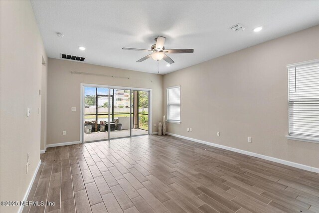 2176 Major Oak St, Jacksonville, FL 32218 - spare room with a ceiling fan, visible vents, wood finished floors, and baseboards