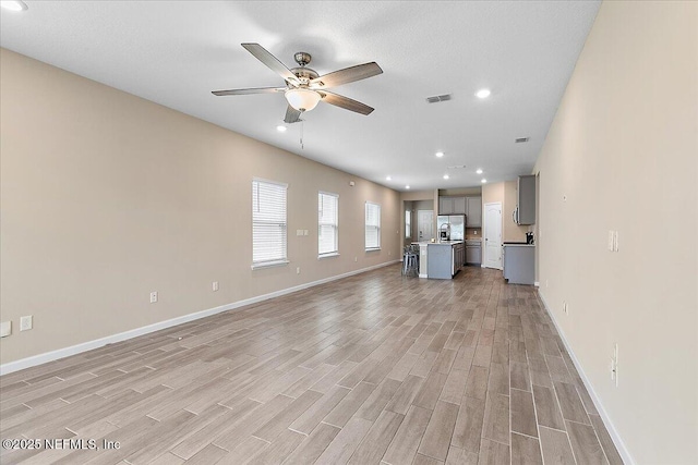 2176 Major Oak St, Jacksonville, FL 32218 - unfurnished living room featuring light wood-style floors, a ceiling fan, recessed lighting, and baseboards