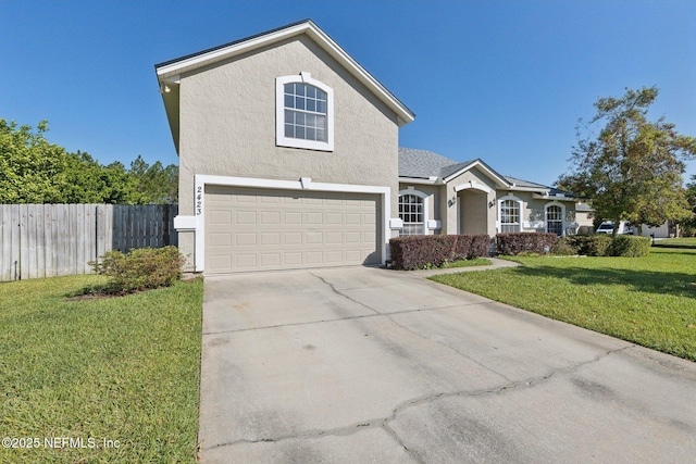 2423 Royal Pointe Dr, Green Cove Springs, FL 32043 - traditional home with concrete driveway, stucco siding, fence, and a front yard