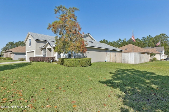 2423 Royal Pointe Dr, Green Cove Springs, FL 32043 - view of front facade featuring a front lawn, fence, a garage, and stucco siding
