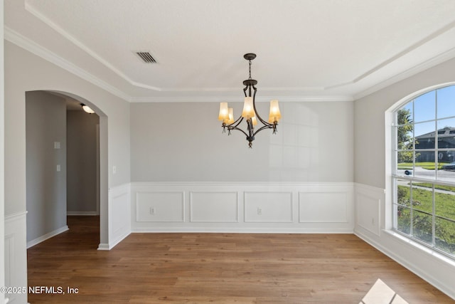 2423 Royal Pointe Dr, Green Cove Springs, FL 32043 - unfurnished dining area featuring arched walkways, a notable chandelier, visible vents, and light wood-type flooring