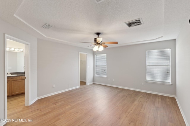 2423 Royal Pointe Dr, Green Cove Springs, FL 32043 - spare room featuring visible vents, baseboards, ceiling fan, a textured ceiling, and light wood finished floors