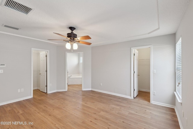 2423 Royal Pointe Dr, Green Cove Springs, FL 32043 - unfurnished bedroom with visible vents, a closet, a spacious closet, light wood-type flooring, and connected bathroom