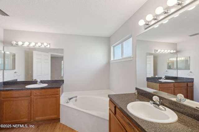 2423 Royal Pointe Dr, Green Cove Springs, FL 32043 - bathroom featuring two vanities, a sink, and wood finished floors