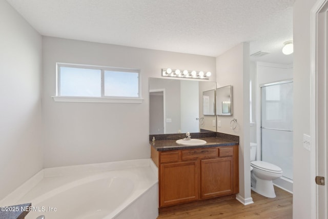 2423 Royal Pointe Dr, Green Cove Springs, FL 32043 - full bathroom featuring a bath, toilet, vanity, wood finished floors, and a stall shower