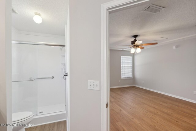 2423 Royal Pointe Dr, Green Cove Springs, FL 32043 - full bathroom with a shower stall, a textured ceiling, wood finished floors, and visible vents