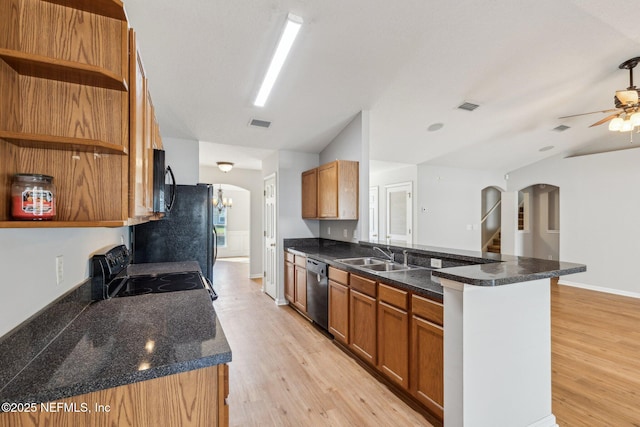 2423 Royal Pointe Dr, Green Cove Springs, FL 32043 - kitchen featuring black appliances, arched walkways, a sink, and open shelves