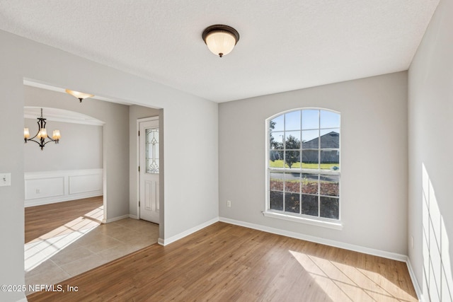 2423 Royal Pointe Dr, Green Cove Springs, FL 32043 - empty room featuring wood finished floors and a notable chandelier