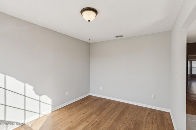 2423 Royal Pointe Dr, Green Cove Springs, FL 32043 - spare room featuring visible vents, baseboards, and wood finished floors