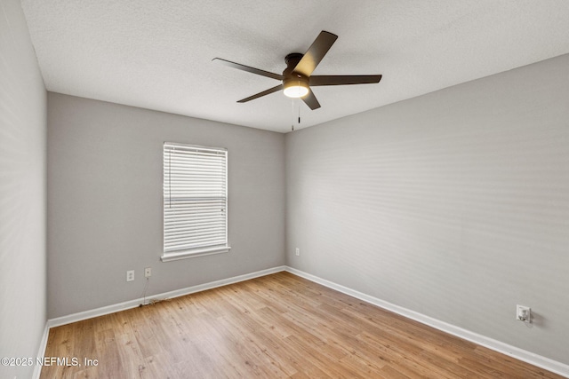 2423 Royal Pointe Dr, Green Cove Springs, FL 32043 - unfurnished room with wood finished floors, baseboards, and a ceiling fan