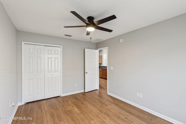 2423 Royal Pointe Dr, Green Cove Springs, FL 32043 - unfurnished bedroom featuring a closet, visible vents, light wood-type flooring, and baseboards
