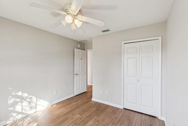 2423 Royal Pointe Dr, Green Cove Springs, FL 32043 - unfurnished bedroom featuring light wood-style floors, a closet, a ceiling fan, visible vents, and baseboards