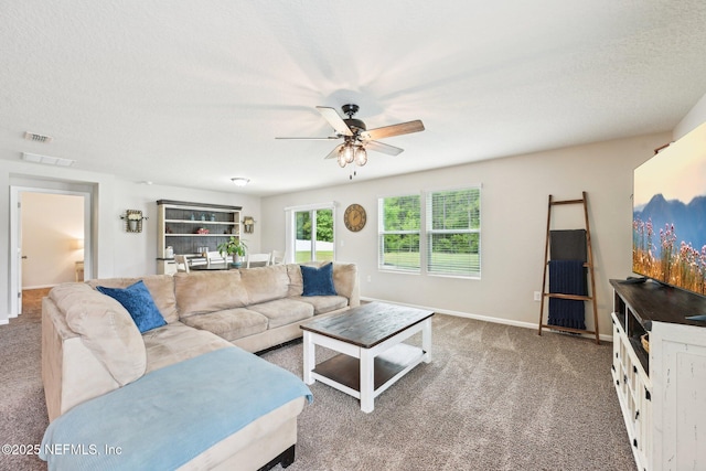 living room with baseboards, ceiling fan, carpet, and visible vents