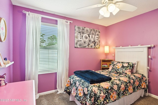 carpeted bedroom featuring baseboards and a ceiling fan