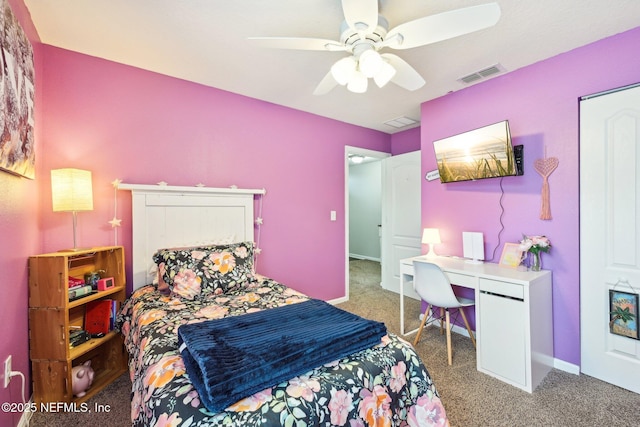 carpeted bedroom with visible vents, a ceiling fan, and baseboards