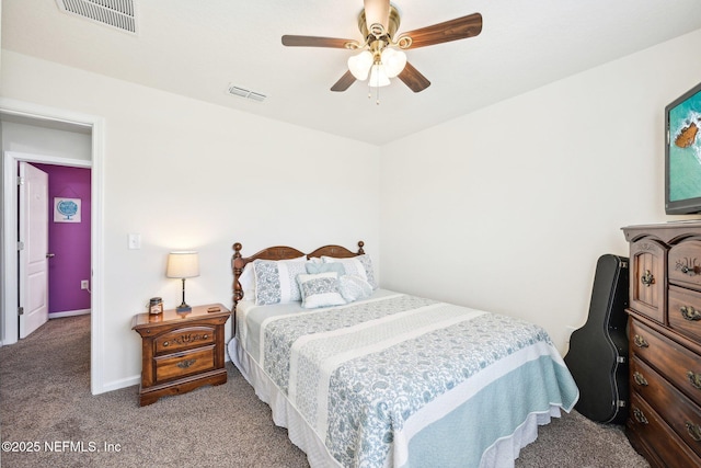 carpeted bedroom with a ceiling fan and visible vents