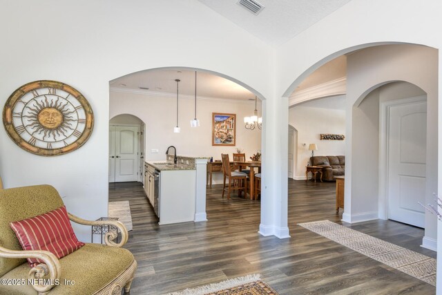 86 Amacano Ln, Saint Augustine, FL 32084 - interior space with visible vents, baseboards, arched walkways, ornamental molding, and dark wood-type flooring