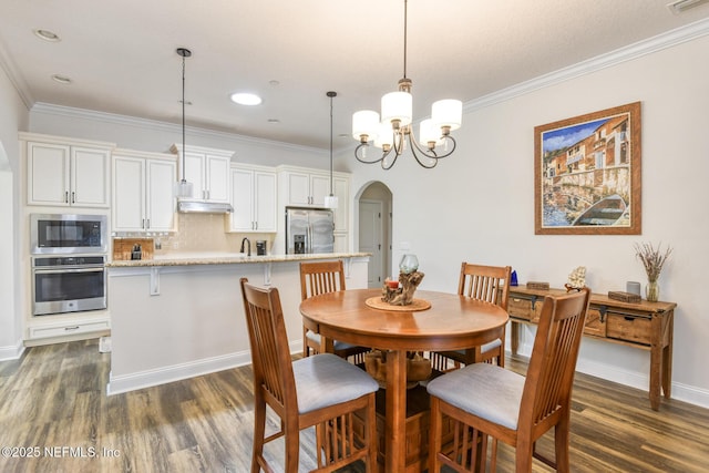 86 Amacano Ln, Saint Augustine, FL 32084 - dining space featuring visible vents, arched walkways, a notable chandelier, dark wood finished floors, and crown molding