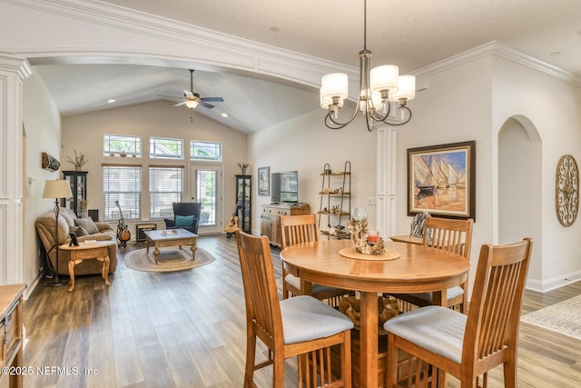 86 Amacano Ln, Saint Augustine, FL 32084 - dining space featuring baseboards, lofted ceiling, arched walkways, ceiling fan with notable chandelier, and wood finished floors