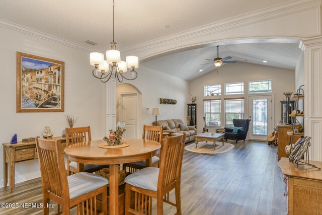 86 Amacano Ln, Saint Augustine, FL 32084 - dining area featuring arched walkways, dark wood-type flooring, visible vents, and ceiling fan with notable chandelier
