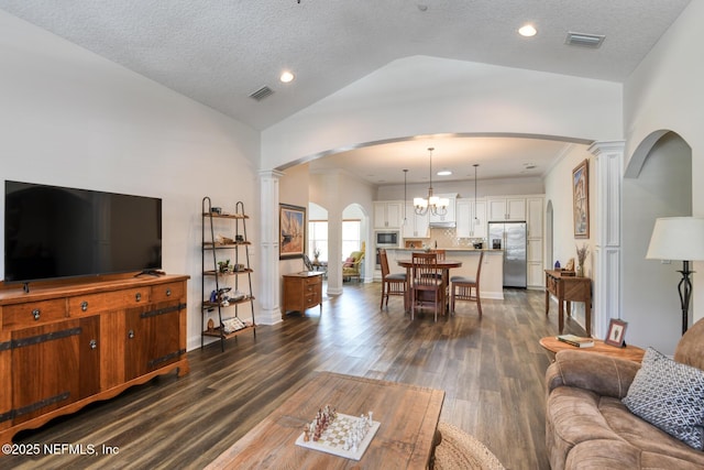 86 Amacano Ln, Saint Augustine, FL 32084 - living room featuring dark wood-type flooring, visible vents, ornate columns, and lofted ceiling