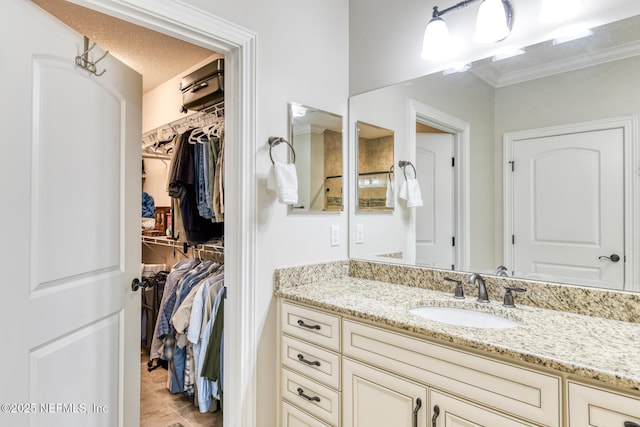 86 Amacano Ln, Saint Augustine, FL 32084 - bathroom featuring tile patterned flooring, vanity, ornamental molding, and a walk in closet
