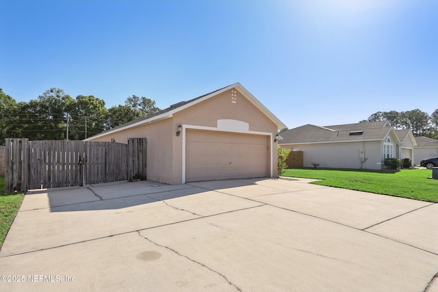 3620 Braeden Ct, Middleburg, FL 32068 - view of front of property featuring a garage, an outdoor structure, fence, stucco siding, and a front lawn