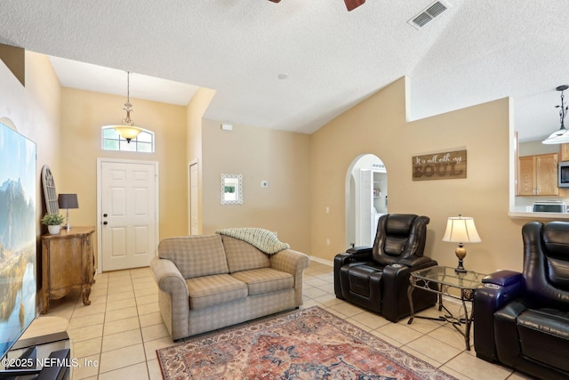 3620 Braeden Ct, Middleburg, FL 32068 - living area featuring light tile patterned floors, ceiling fan, arched walkways, a textured ceiling, and visible vents