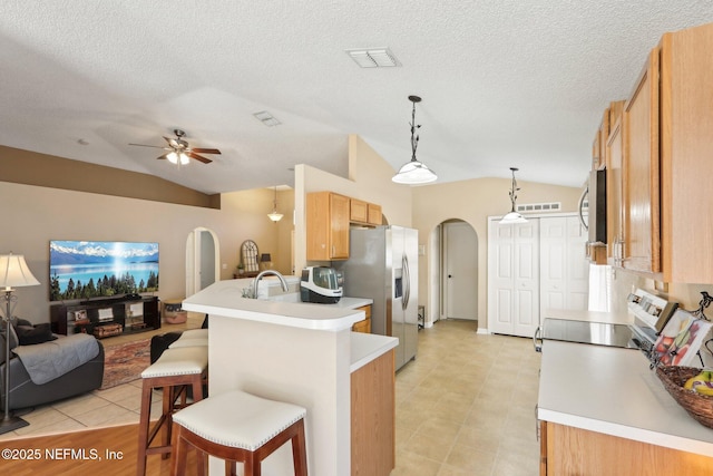 3620 Braeden Ct, Middleburg, FL 32068 - kitchen with stainless steel appliances, arched walkways, open floor plan, and lofted ceiling