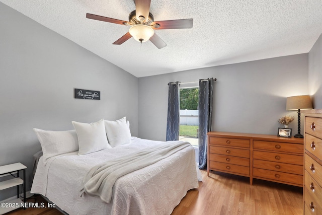 3620 Braeden Ct, Middleburg, FL 32068 - bedroom with light wood finished floors, a textured ceiling, vaulted ceiling, and ceiling fan