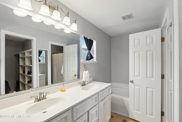 3620 Braeden Ct, Middleburg, FL 32068 - full bathroom featuring a sink, visible vents, double vanity, and a garden tub