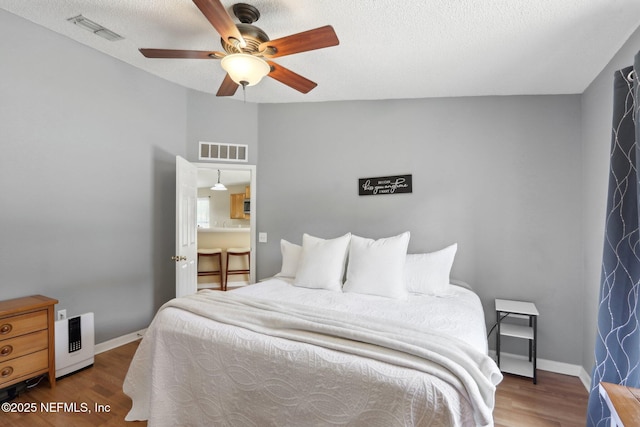 3620 Braeden Ct, Middleburg, FL 32068 - bedroom with a textured ceiling, wood finished floors, baseboards, and visible vents
