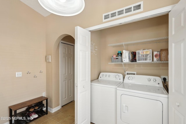 3620 Braeden Ct, Middleburg, FL 32068 - laundry area with laundry area, arched walkways, visible vents, light tile patterned flooring, and washing machine and dryer