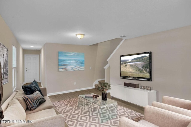 7609 Eaton Ave, Jacksonville, FL 32211 - living area with wood finished floors, baseboards, visible vents, and stairs