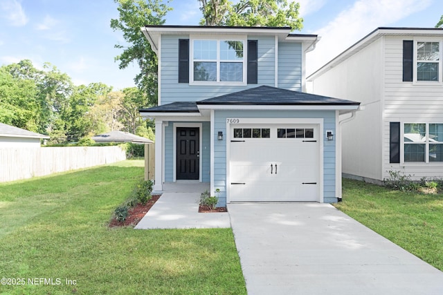 7609 Eaton Ave, Jacksonville, FL 32211 - view of front of house featuring a front lawn, a shingled roof, a garage, and concrete driveway