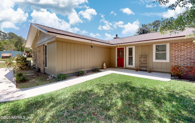 4147 Saunders Dr, Middleburg, FL 32068 - ranch-style home featuring brick siding, a patio, board and batten siding, and a front yard
