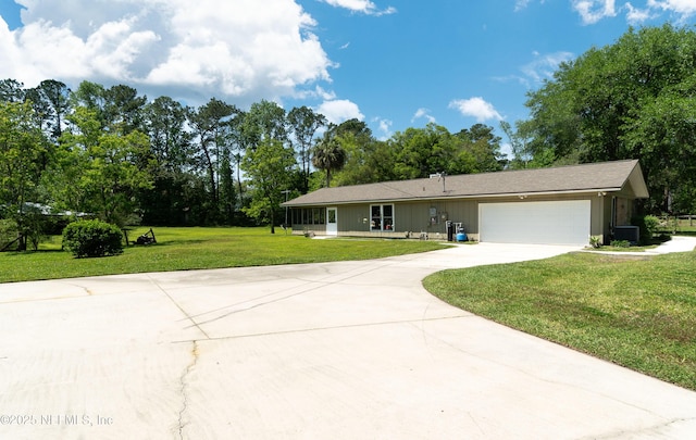 4147 Saunders Dr, Middleburg, FL 32068 - ranch-style house with a garage, a front lawn, cooling unit, and concrete driveway