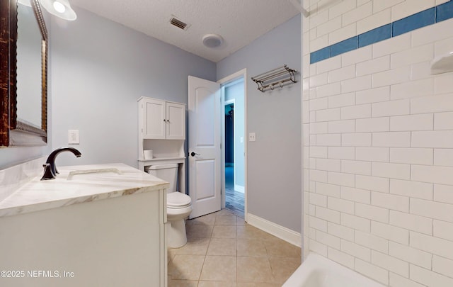 4147 Saunders Dr, Middleburg, FL 32068 - full bathroom featuring tile patterned floors, a textured ceiling, vanity, baseboards, and toilet