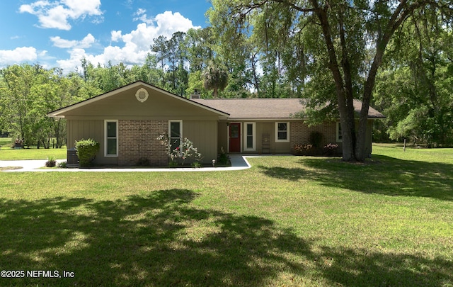 4147 Saunders Dr, Middleburg, FL 32068 - ranch-style house featuring brick siding and a front lawn
