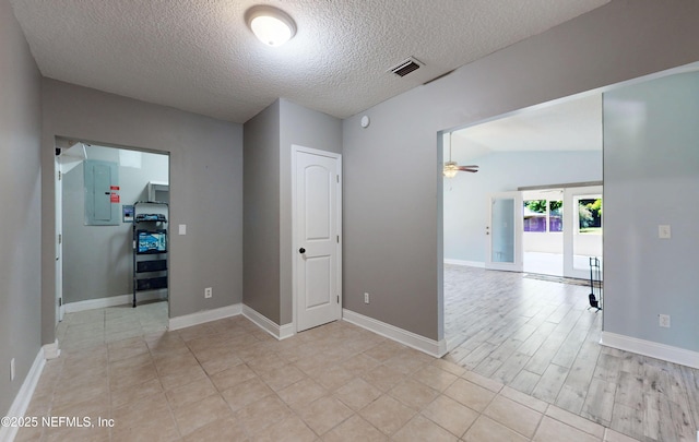 4147 Saunders Dr, Middleburg, FL 32068 - unfurnished room featuring electric panel, a textured ceiling, baseboards, visible vents, and ceiling fan