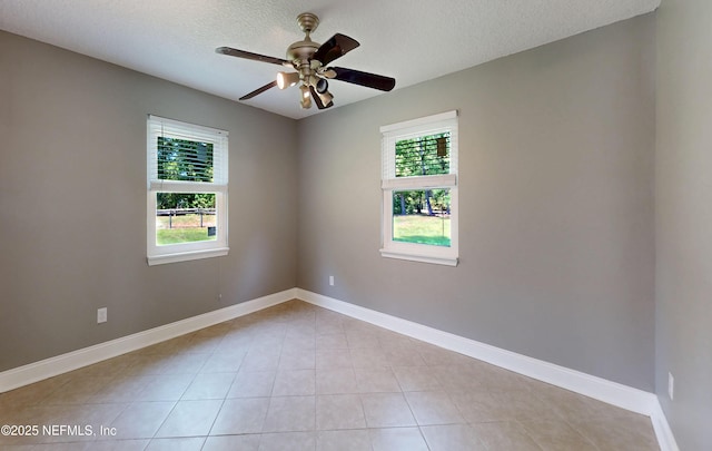 4147 Saunders Dr, Middleburg, FL 32068 - empty room with ceiling fan, a wealth of natural light, a textured ceiling, and light tile patterned floors