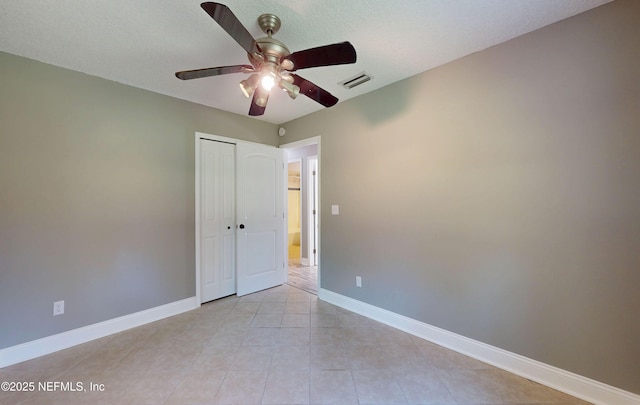 4147 Saunders Dr, Middleburg, FL 32068 - unfurnished bedroom featuring a ceiling fan, a closet, light tile patterned floors, baseboards, and visible vents