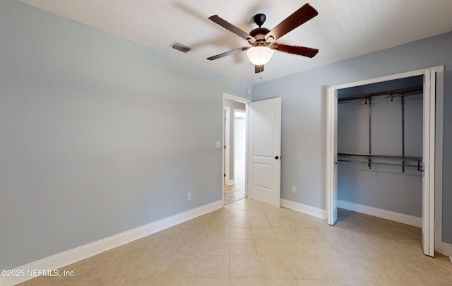 4147 Saunders Dr, Middleburg, FL 32068 - unfurnished bedroom with a textured ceiling, baseboards, visible vents, a closet, and ceiling fan